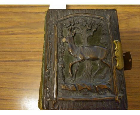 VICTORIAN PHOTO ALBUM - A Victorian portrait photo album with carved wooden boards, brass clasp