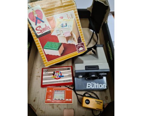 A box of vintage games to include a Sindy writing bureau in box, The Button polaroid land camera, a Supersnaps Flicker, a Mic