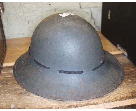 A WWII helmet, the leather interior marked 'S.M.LD. 1941".  
