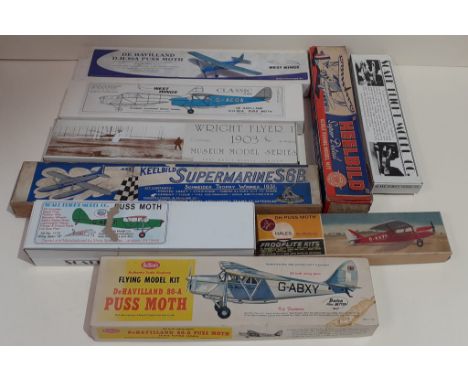 A box of rubber band powered flying model aeroplane kits.  