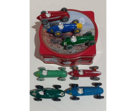 A tin containing 7 Dinky die-cast model racing cars.After inspection it looks like the Dinky die-cast model racing cars have 