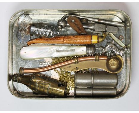 A tin of assorted collectables including a novelty combination cigar cutter/vesta case modelled as a Veuve Cliqout champagne 