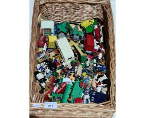 A basket containing Dinky die-cast model vehicles and lead farmyard animals and figures. 