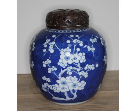 A Chinese blue and white porcelain ginger jar, bearing six character Kangxi mark withint double circle to base, with carved w