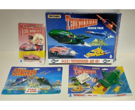 A box of Matchbox Thunderbird die-cast model vehicles and a Matchbox Stingray and the Terror Fish die-cast model. 