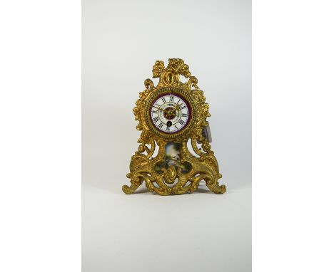 French Style Clock. Decorative mantle clock with gilt ormolu decoration. Porcelain dial with floral decoration and countrysid