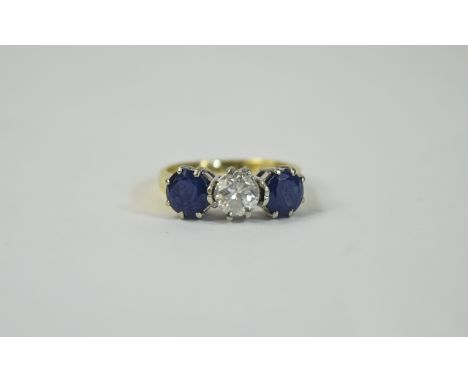 18ct Gold Diamond and Sapphire 3 Stone Ring Central round brilliant cut diamond set between 2 round cut sapphires. Central di