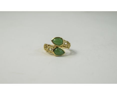 Green Jade Crossover Ring, openwork shoulders to the 14ct gold vermeil and silver shank, holding two bezel set, pear cut, gre