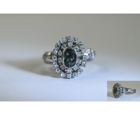 18ct White Gold Diamond Cluster Ring. Set with a central fancy green Sapphire, surrounded by 26 round cut diamonds. Unmarked,