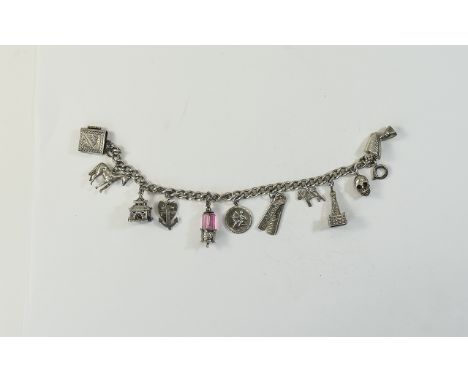 Vintage Silver Charm Bracelet Loaded with 11 Silver Charms. Includes a Scull Charm, Horse, Book, Japanese Lamp, Comb, Egyptia