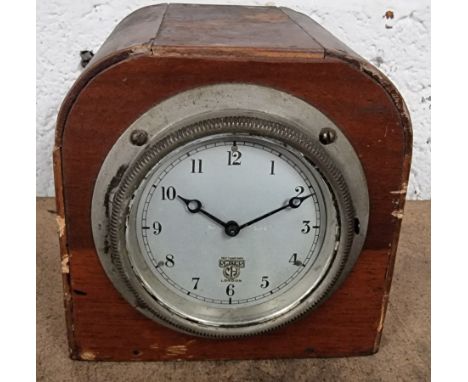 A Smith dashboard mounted clock, mounted in a display case.The clock winds and is ticking.