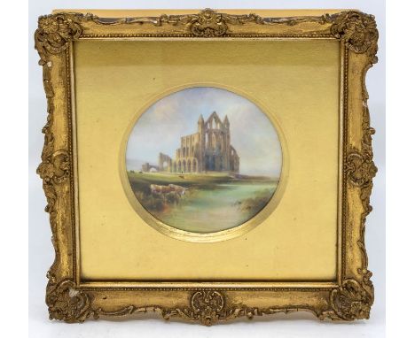 A Royal Worcester circular plaque, painted with Whitby Abbey and cattle with river in foreground, signed by H Davis, date cod