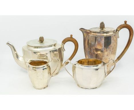 A George VI silver matched four piece tea service to include teapot, hot water or coffee pot, sugar bowl and milk jug, facete