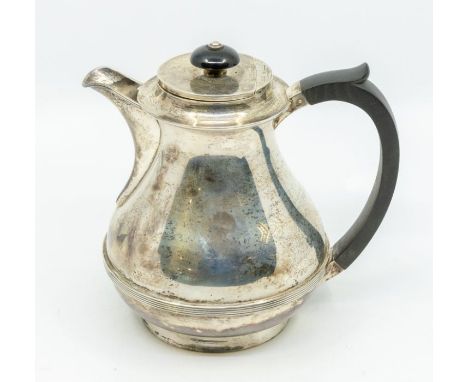 A George VI silver hot water jug, pear shaped body with ribbed section, ebonised handle and finial, by J Chatterley, Birmingh