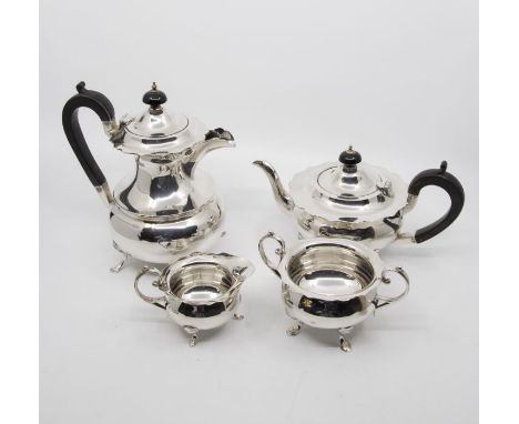 A George V plain silver four piece tea service to include: teapot, hot water jug, sugar bowl and milk jug, flared cut rims ab