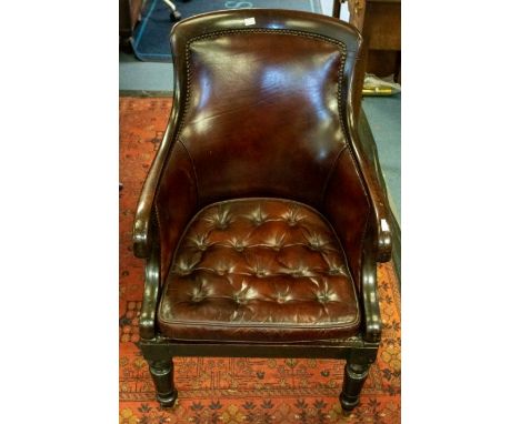 A 19th Century mahogany and studded leather armchair, shaped back with down-swept arms, drop-in button-back cushion, turned f