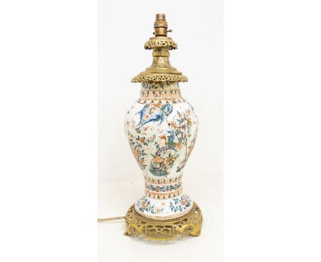 An 18th century Delft ware tin glazed wrythen vase, painted with fanciful birds and flowers, converted to lamp, applied with 