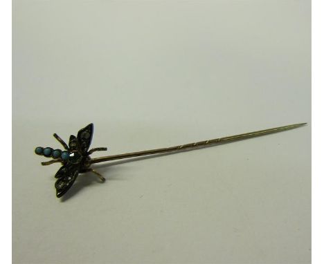 A gold insect stick pin set with Turquoise and Diamond in the form of a Dragonfly.  6cms l. 