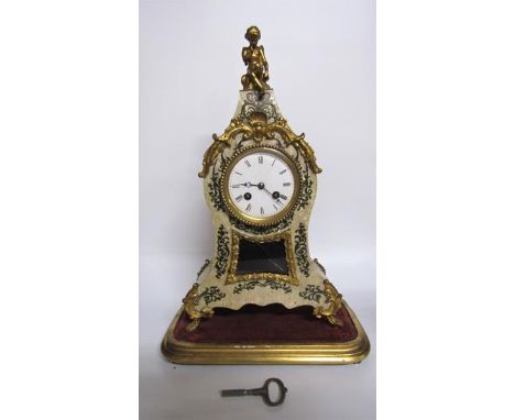 A mid 19c French mantel clock the waisted case having a glazed pendulum aperture below the dial and decorated with gilt mount