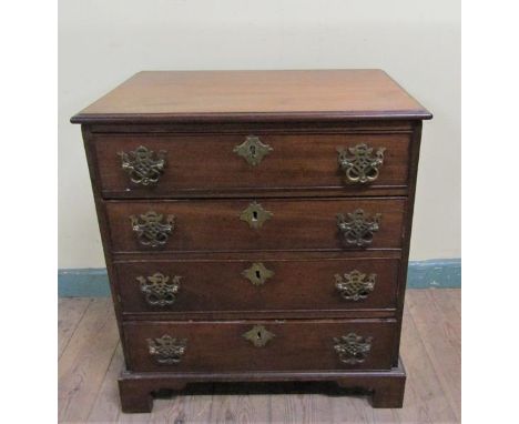 A late Georgian mahogany chest of four long drawers with cut brass back plates and swing handles.  On bracket feet.  64cms w 