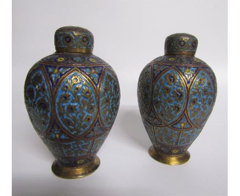 A pair of 19c Indian brass and enamel tea canisters of baluster form decorated with ovoid panels of leaf and flowers. Each 15