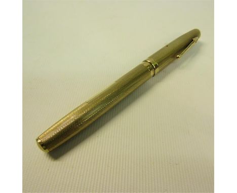A Waterman 9ct gold engine turned fountain pen.  13.5cms l. 