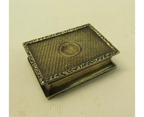 An early 20c Georgian style silver snuff box of rectangular engine turned form with cast leaf and floral borders.  Makers mar