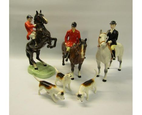 A Beswick hunting group comprising huntsman on rearing horse model no. 868 - 25.5cms h, huntsman model no. 1501 - 20.5cms h, 