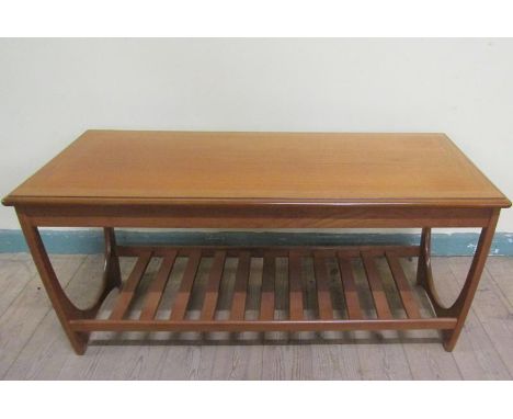 A G Plan teak low table of rectangular form with moulded edge having a slatted under tier shelf.  110cms w x 52cms h. 