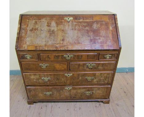 A mid Georgian figured walnut veneered cross banded bureau with fall front and fitted interior over base with two short and o