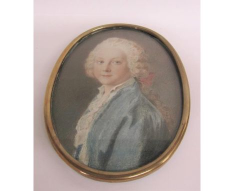 Early 19c portrait watercolour miniature of a young gentleman with ribbon in his hair. Oval framed and glazed.  15cms x 10cms