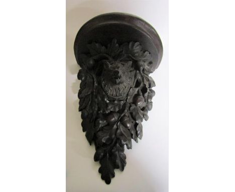 A 19c Black Forest acorn and oak leaf carved wall bracket with a boars head mask.  28cm w x 39cm h. 