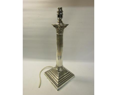 An Edwardian silver Corinthian column table lamp with electrical fittings.  Makers mark for Goldsmiths &amp; Silversmiths Co.