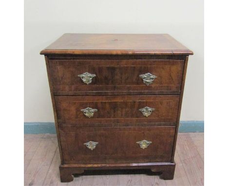 A mid Georgian style figured walnut veneered small chest of three long drawers.  The top and drawer faces cross banded and wi