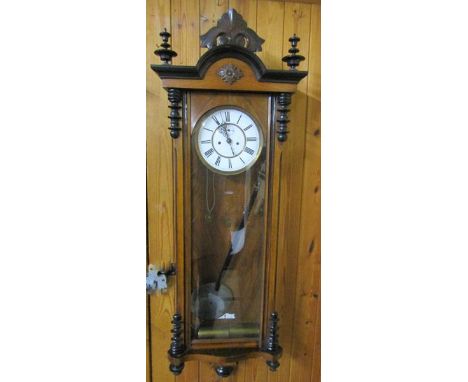 A late 19c German two weight Vienna Regulator in glazed walnut and ebonised case, the front door having turnings to the top a