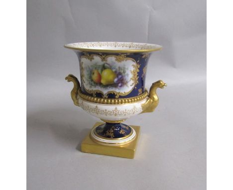A late 19c Royal Worcester vase painted with fruit and having gilt Eagle handles, the pedestal vase supported on a square gil