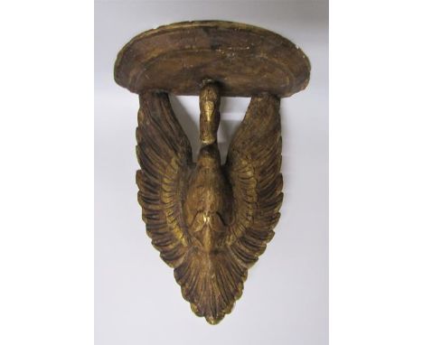 A 19c carved wooden stucco gilded wall bracket supported by a swan with open wings.  37cms w x 47cms h. 