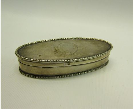 An Edwardian silver toothpick box of oval form with beaded rim, engine turned and enclosed by a hinged cover.  Makers mark fo