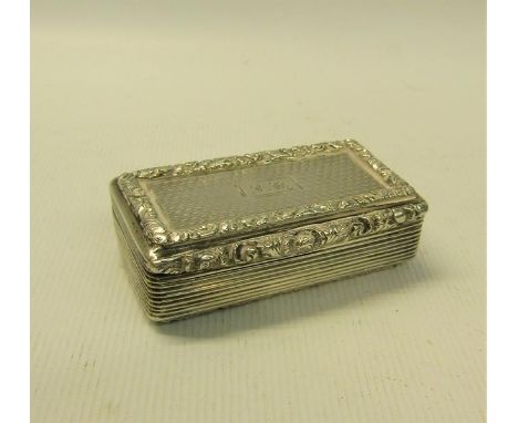 A William IV silver snuff box of rectangular form, the box with ribbed decoration and leaf and flower cast borders.  Engine t