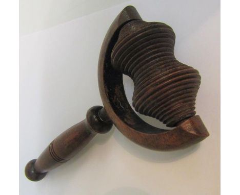 A 19c Sycamore massager with a rib carved roller in a prong frame with a turned wood handle.  19cms l. 