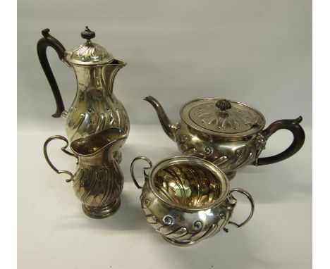 A four piece silver tea and coffee service of baluster form.  The coffee and tea pot with hinged, slightly domed covered, all