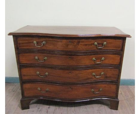 A George III figured mahogany serpentine chest of four long graduated drawers with brass swing pull handles, on bracket feet.