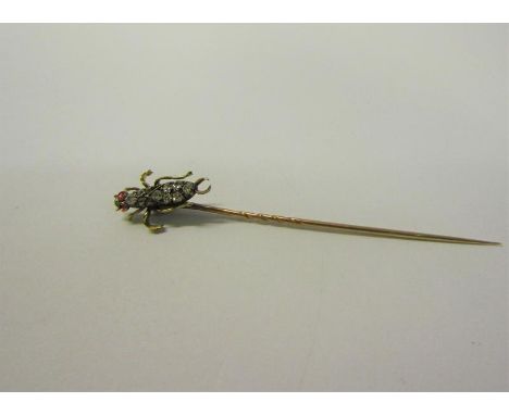 A gold stick pin with Diamond and Ruby set insect terminal.  6cms l. 