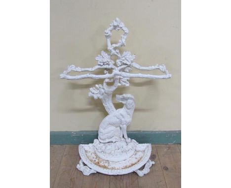 A Victorian cast iron stick stand cast as a seated dog under a tree, white painted.  72cms h. 