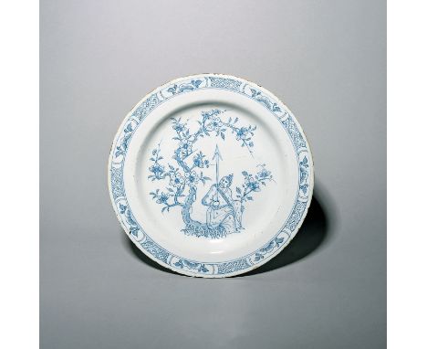 A large delftware plate  c.1760-70, probably Bristol or Liverpool, well painted in a pale blue with a Chinese warrior figure 
