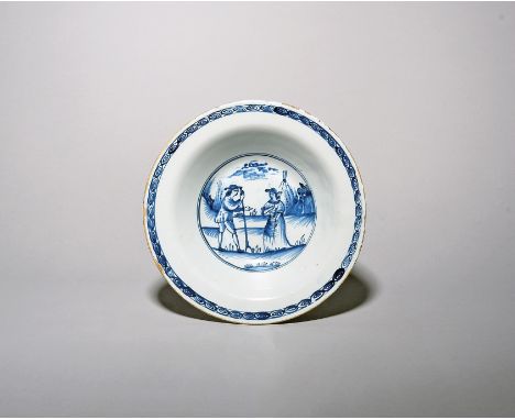 A Liverpool delftware shallow bowl  c.1760, the interior painted in blue with gardeners or haymakers, a man holding a hayfork