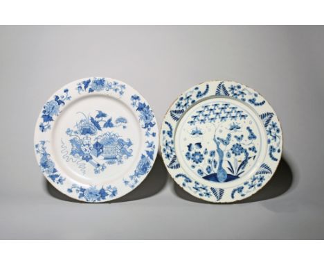 Two delftware chargers  mid 18th century, one Liverpool and painted with vases of flowers, the rim with six flower sprays, la