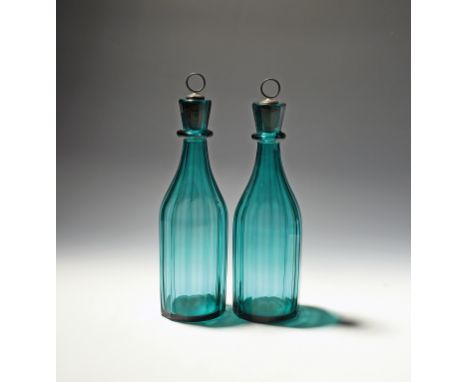 A pair of green glass decanters and stoppers  19th century, the bottle shaped bodies vertically faceted, with a single neck r
