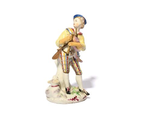 A Bow figure of a Scottish musician or piper c.1758, wearing a tartan sash and breeches and a blue beret, playing the bagpipe