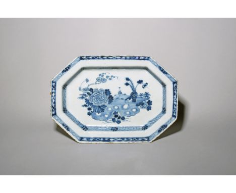 A delftware octagonal charger  c.1760, Dublin or Liverpool, painted with peacock feathers in a vase beside a large chrysanthe